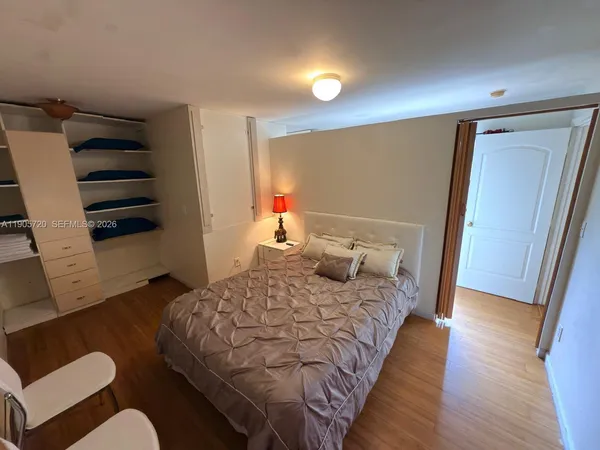 a bedroom with bed and a dresser