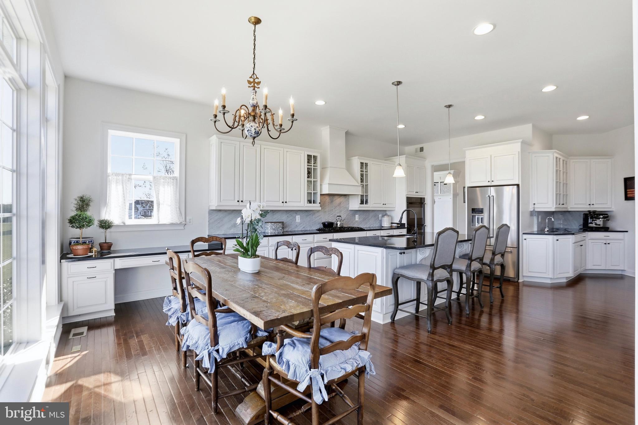 36972 Bridle Ridge Lane Purcellville, VA 20132 - Photo 9 of 44 a view of a dining room and livingroom with furniture wooden floor a chandelier