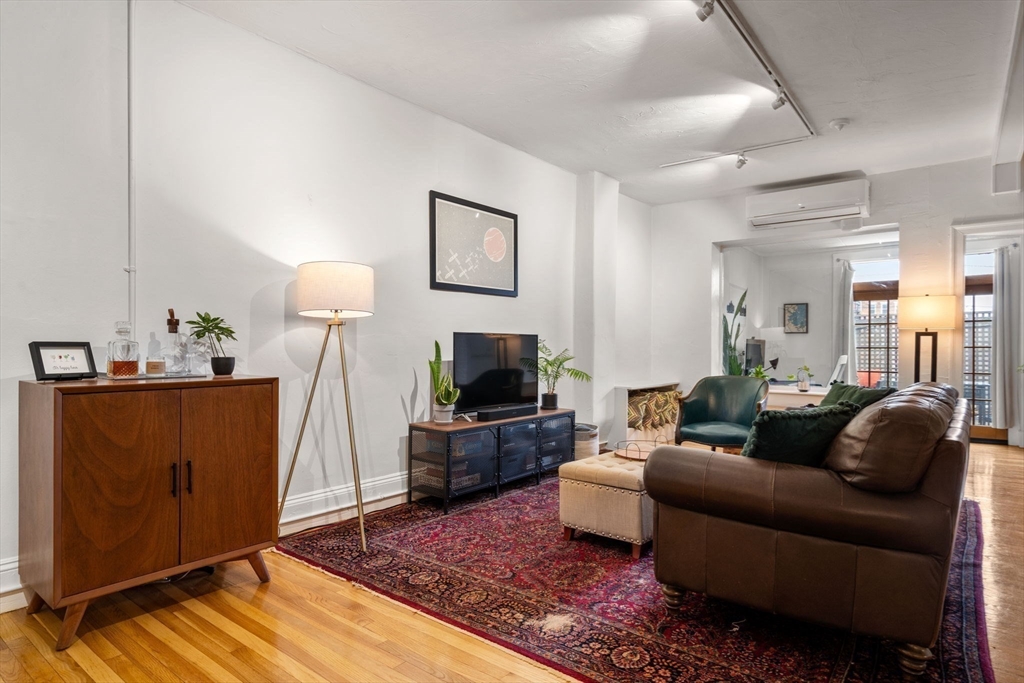 63 Maverick Square, Unit 5 Boston, MA 02128 - Photo 12 of 23 a living room with furniture and a flat screen tv