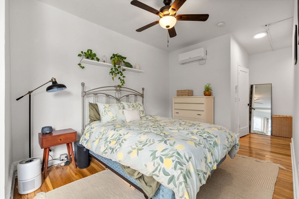 63 Maverick Square, Unit 5 Boston, MA 02128 - Photo 14 of 23 a bedroom with a bed and a chandelier