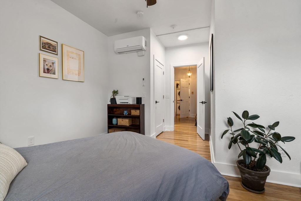 63 Maverick Square, Unit 5 Boston, MA 02128 - Photo 16 of 23 a bedroom with a bed and a potted plant