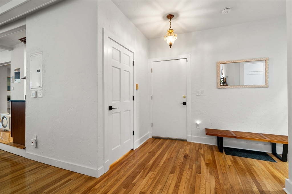 63 Maverick Square, Unit 5 Boston, MA 02128 - Photo 19 of 23 a view of a room with wooden floor and brick walls