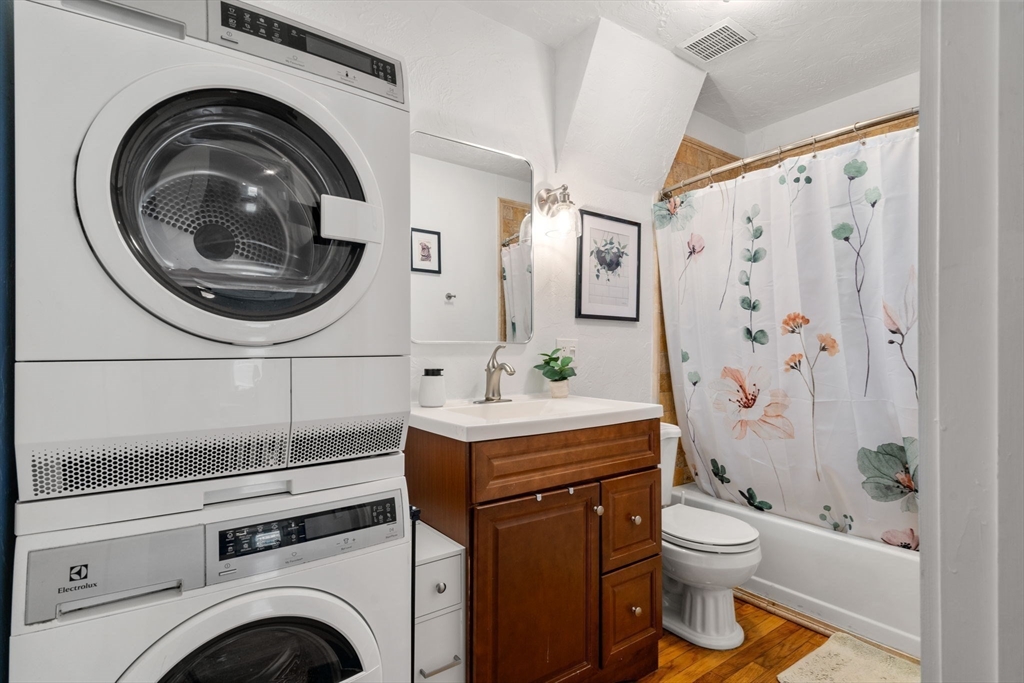 63 Maverick Square, Unit 5 Boston, MA 02128 - Photo 20 of 23 a bathroom with a sink a toilet and a shower