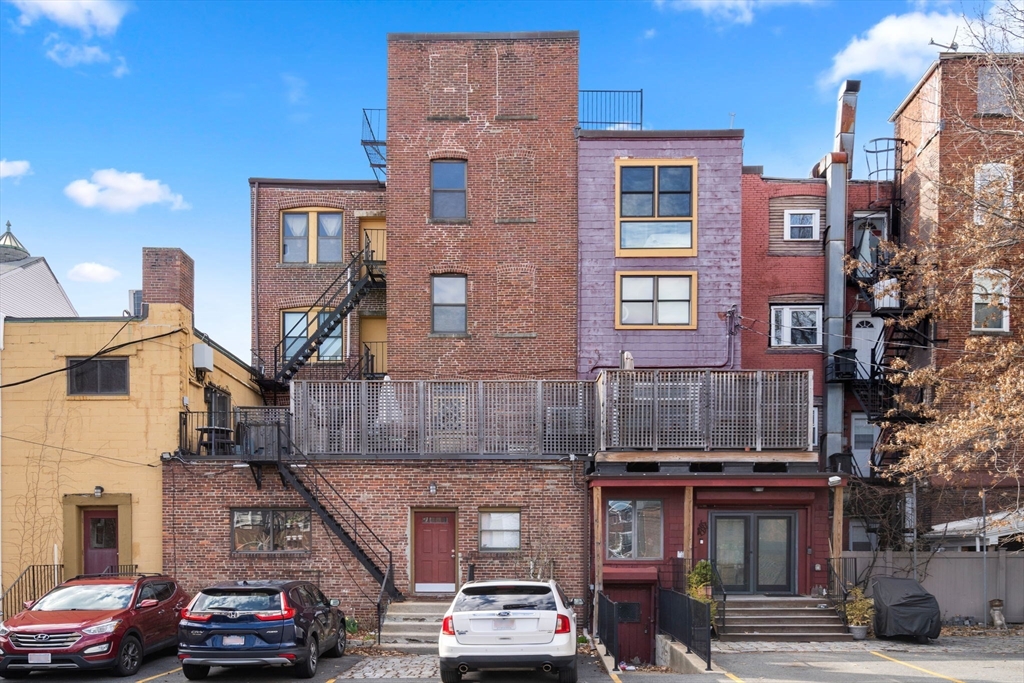 63 Maverick Square, Unit 5 Boston, MA 02128 - Photo 21 of 23 a car parked in front of a building