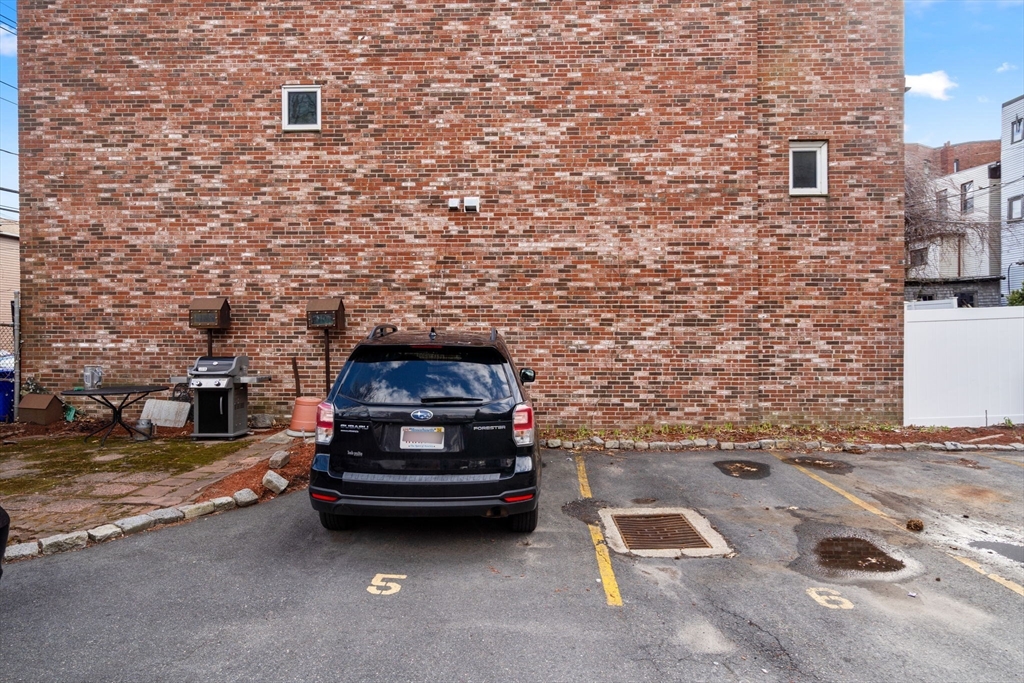 63 Maverick Square, Unit 5 Boston, MA 02128 - Photo 22 of 23 a car parked in parking lot of building