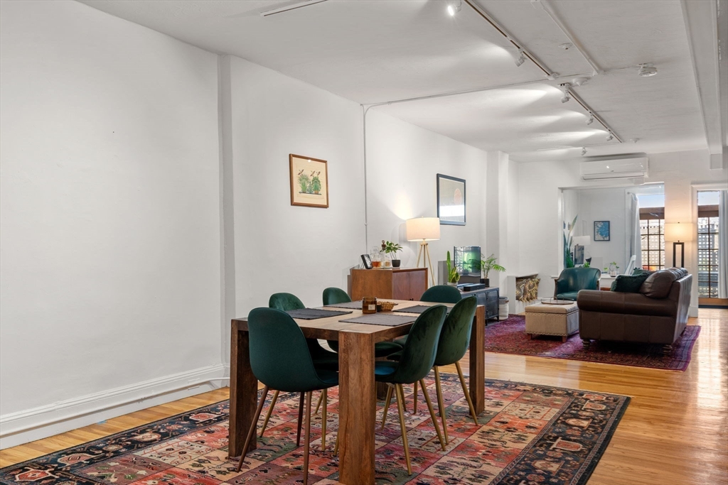 63 Maverick Square, Unit 5 Boston, MA 02128 - Photo 4 of 23 a view of a dining room with furniture and wooden floor