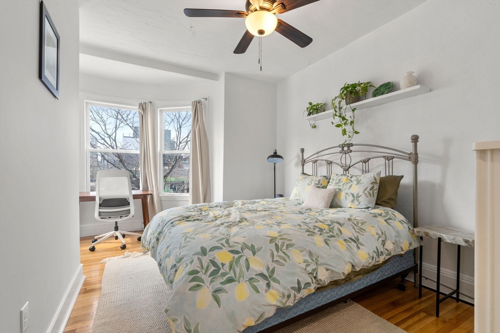 63 Maverick Square, Unit 5 Boston, MA 02128 - Photo 5 of 23 a bedroom with a bed and window