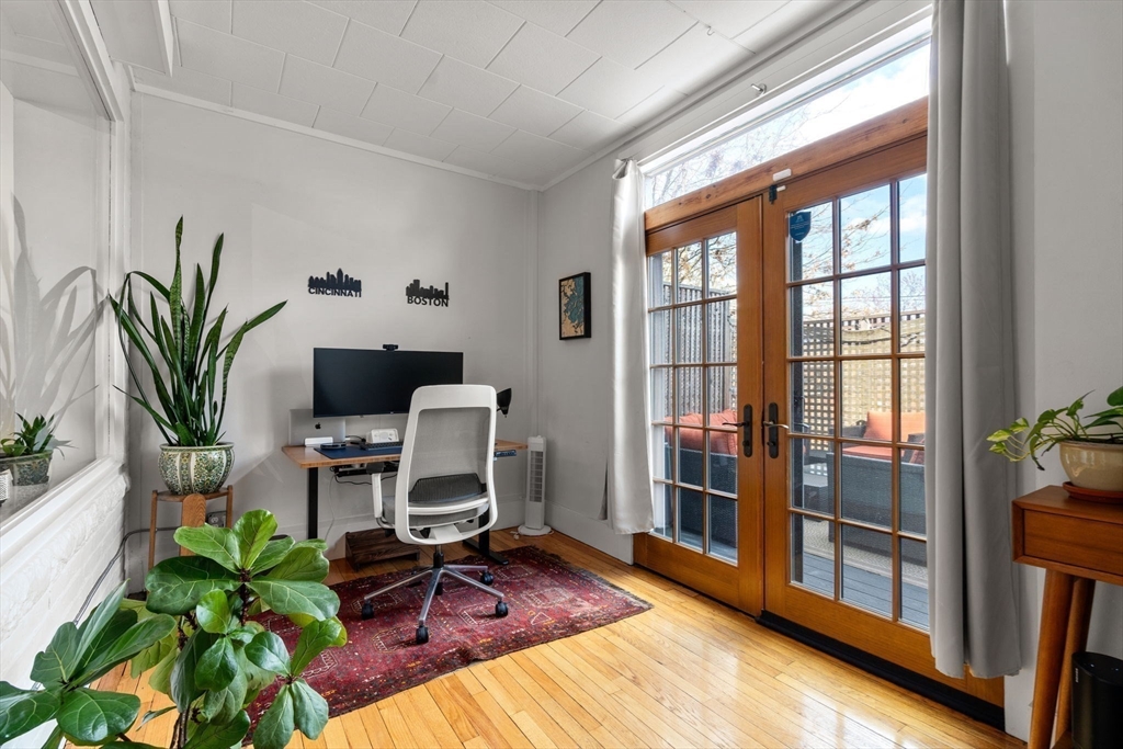 63 Maverick Square, Unit 5 Boston, MA 02128 - Photo 6 of 23 a view of a workspace with furniture and a potted plant