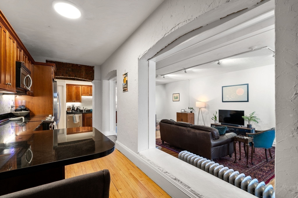 63 Maverick Square, Unit 5 Boston, MA 02128 - Photo 10 of 23 a living room with furniture and a flat screen tv