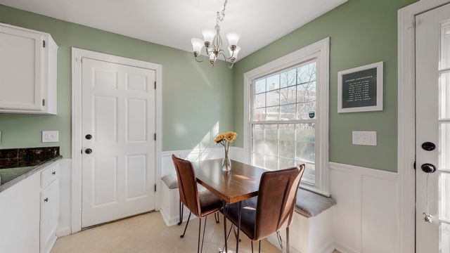 a view of a dining room with furniture and chandelier