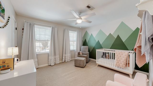 a bedroom with furniture and a large window