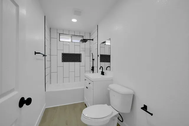 a bathroom with a toilet a sink and shower
