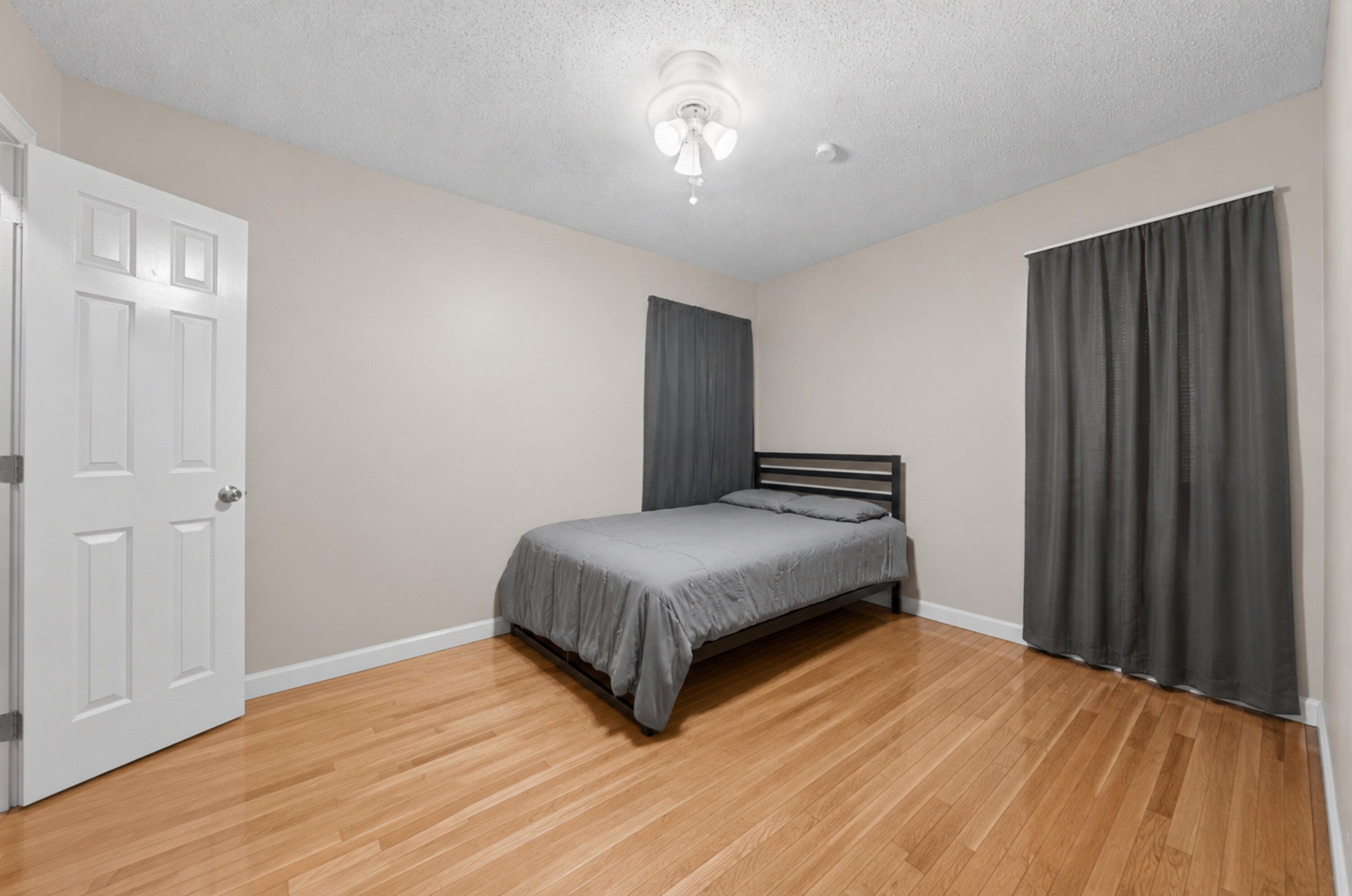 2212 22nd Street Lubbock, TX 79411 - Photo 11 of 14 a bedroom with a bed and wooden floor