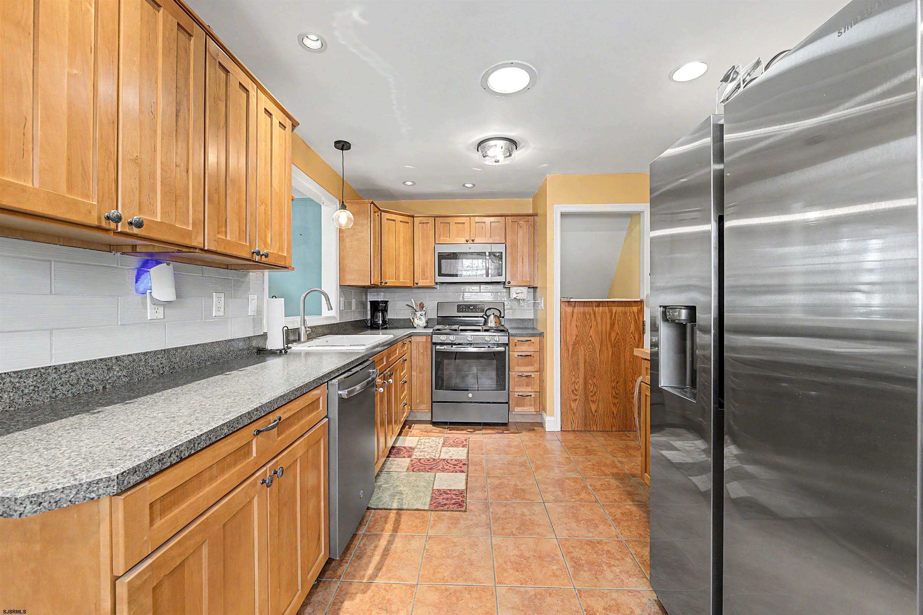 125 Exton Road Somers Point, NJ 08244 - Photo 12 of 35 a kitchen with stainless steel appliances granite countertop a refrigerator a sink and dishwasher