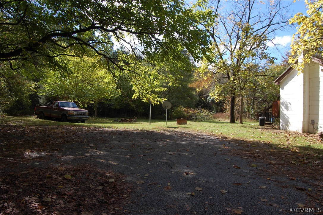 3711 Three Chopt Road Gum Spring, VA 23065 - Photo 3 of 15 a view of a yard with plants and trees