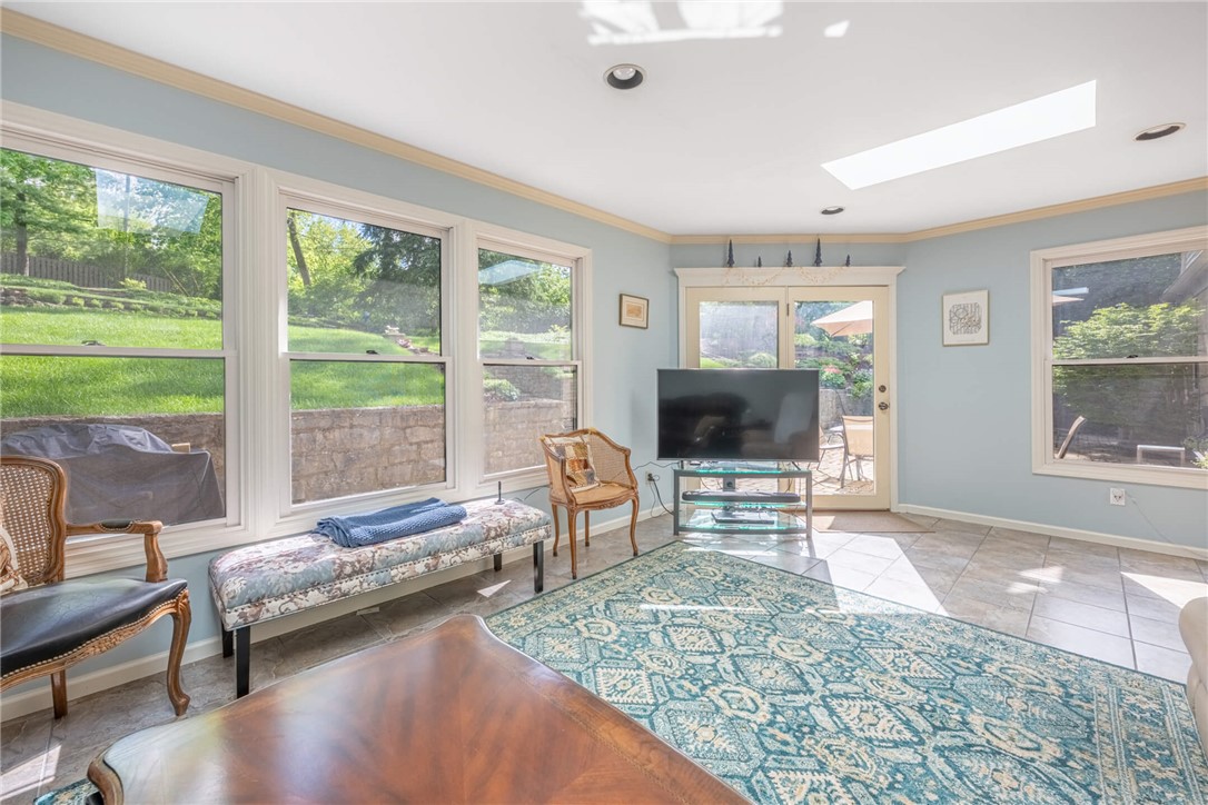 156 West Hadley Road Dayton, OH 45419 - Photo 19 of 71 This bright sunroom features skylights and tiled flooring, offering a perfect blend of indoor comfort and outdoor views.