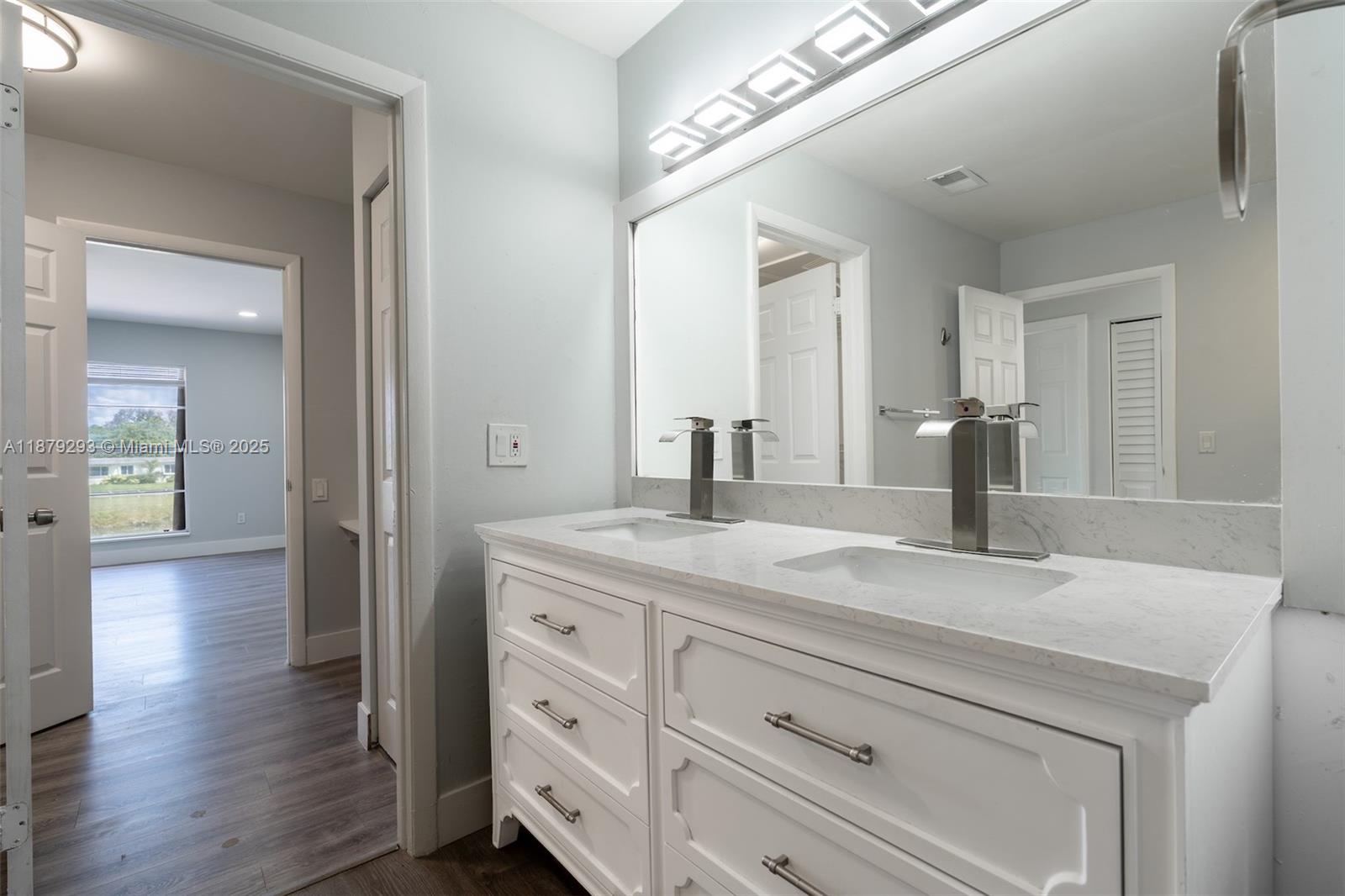6211 Southwest 116th Place, Unit C22 Miami, FL 33173 - Photo 15 of 33 a bathroom with a granite countertop sink and a mirror