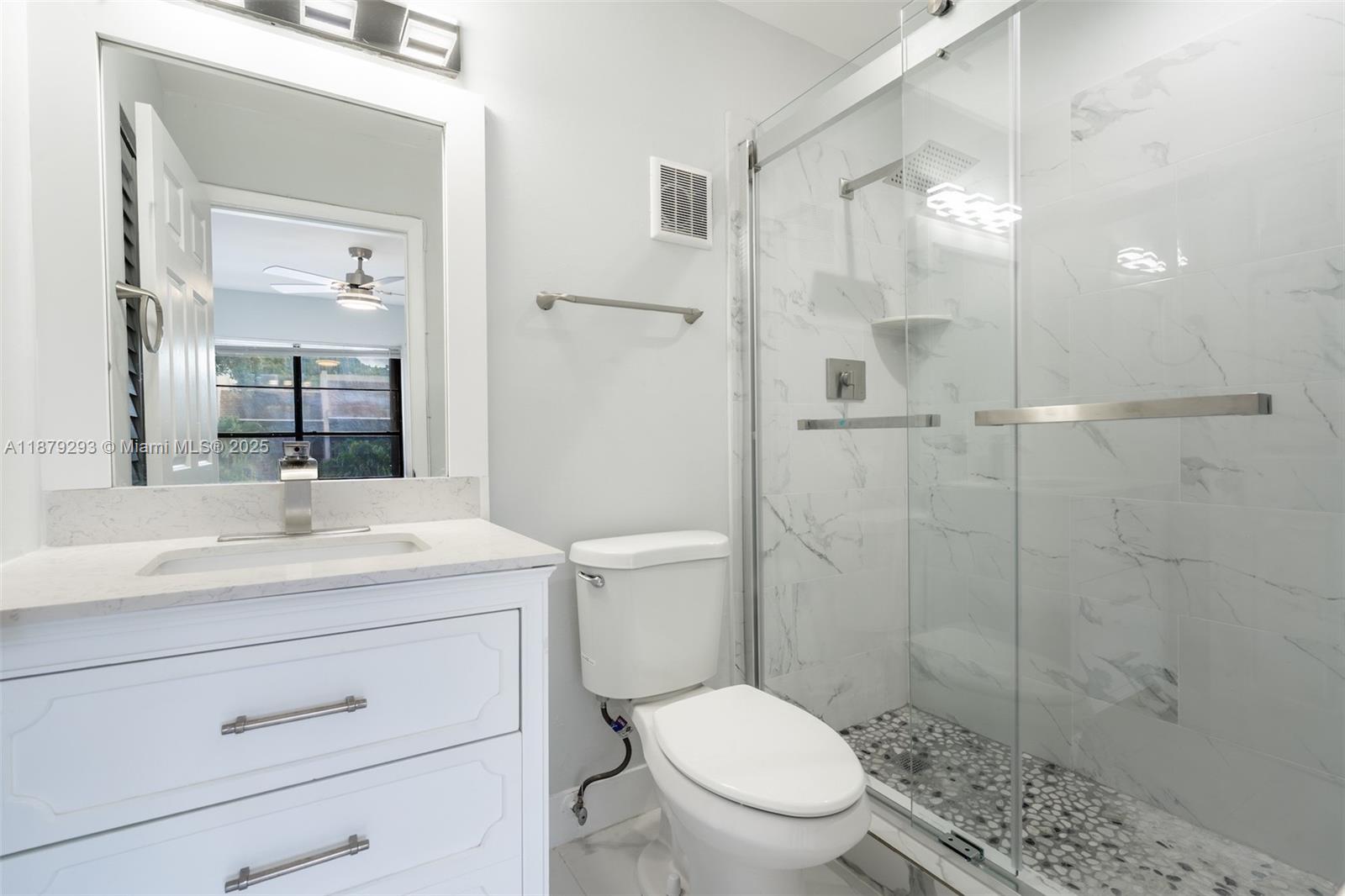 6211 Southwest 116th Place, Unit C22 Miami, FL 33173 - Photo 22 of 33 a bathroom with a shower sink vanity mirror and toilet