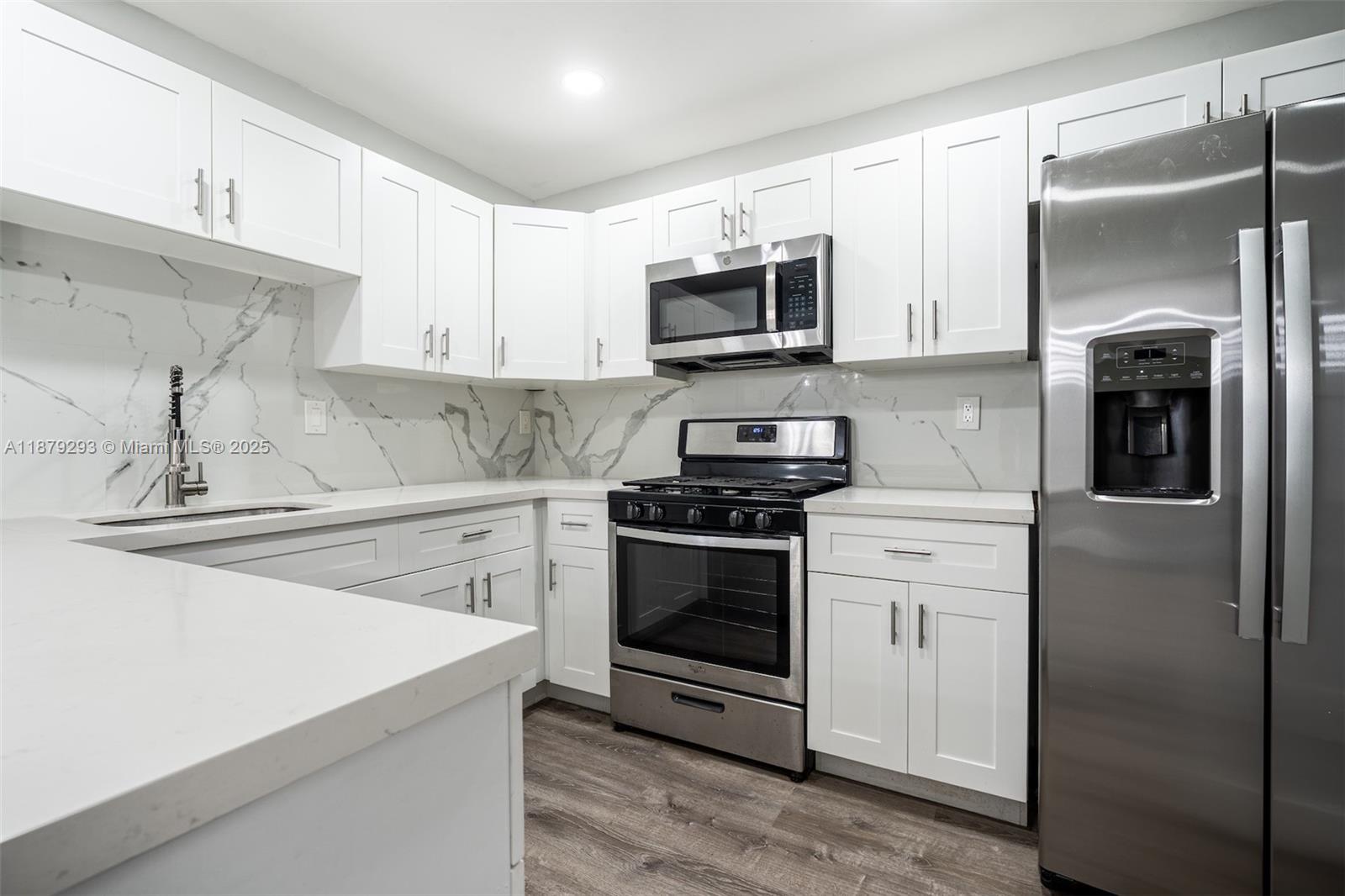 6211 Southwest 116th Place, Unit C22 Miami, FL 33173 - Photo 3 of 33 a kitchen with stainless steel appliances white cabinets and a sink