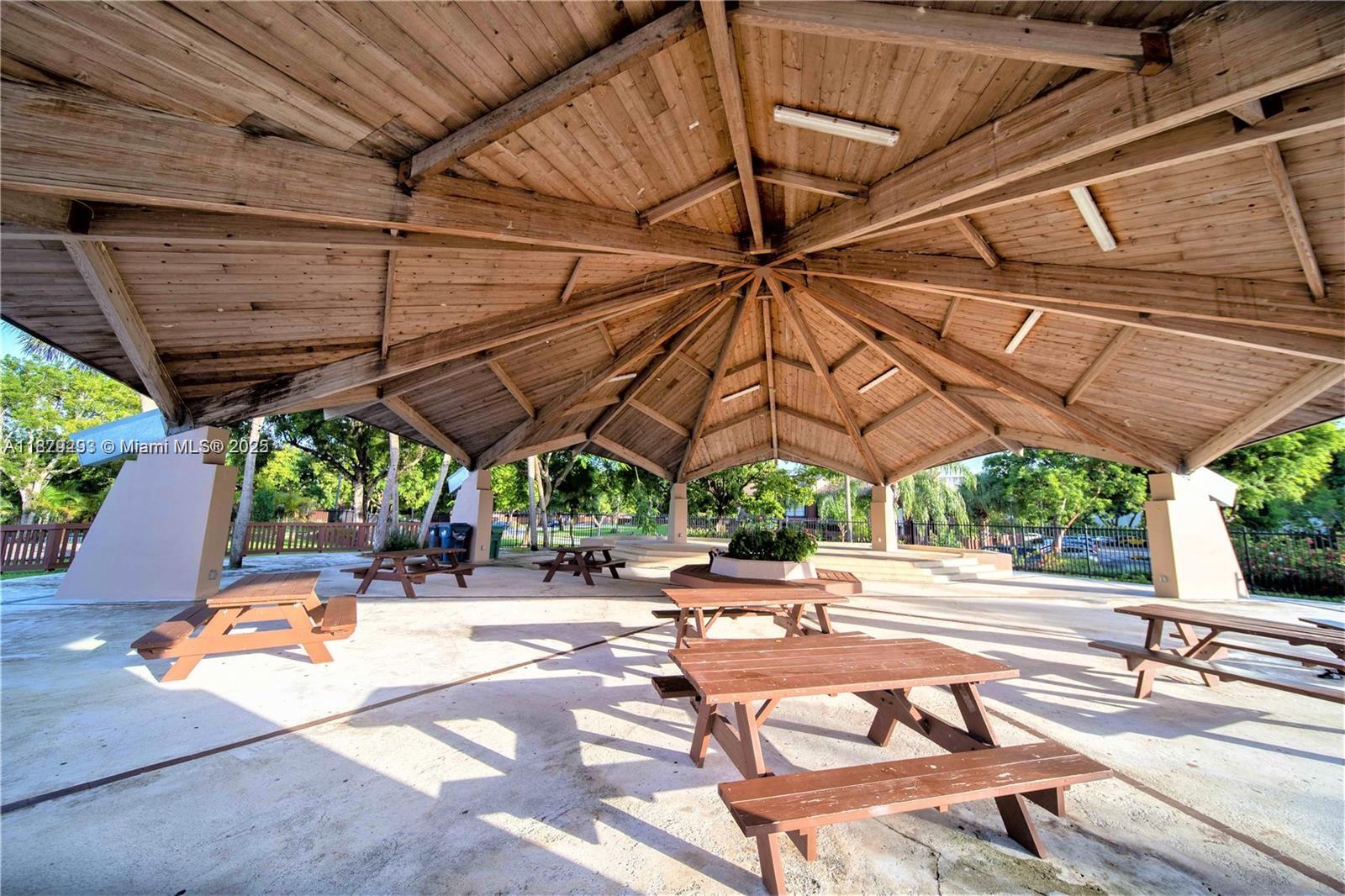 6211 Southwest 116th Place, Unit C22 Miami, FL 33173 - Photo 32 of 33 a patio with a patio table and chairs