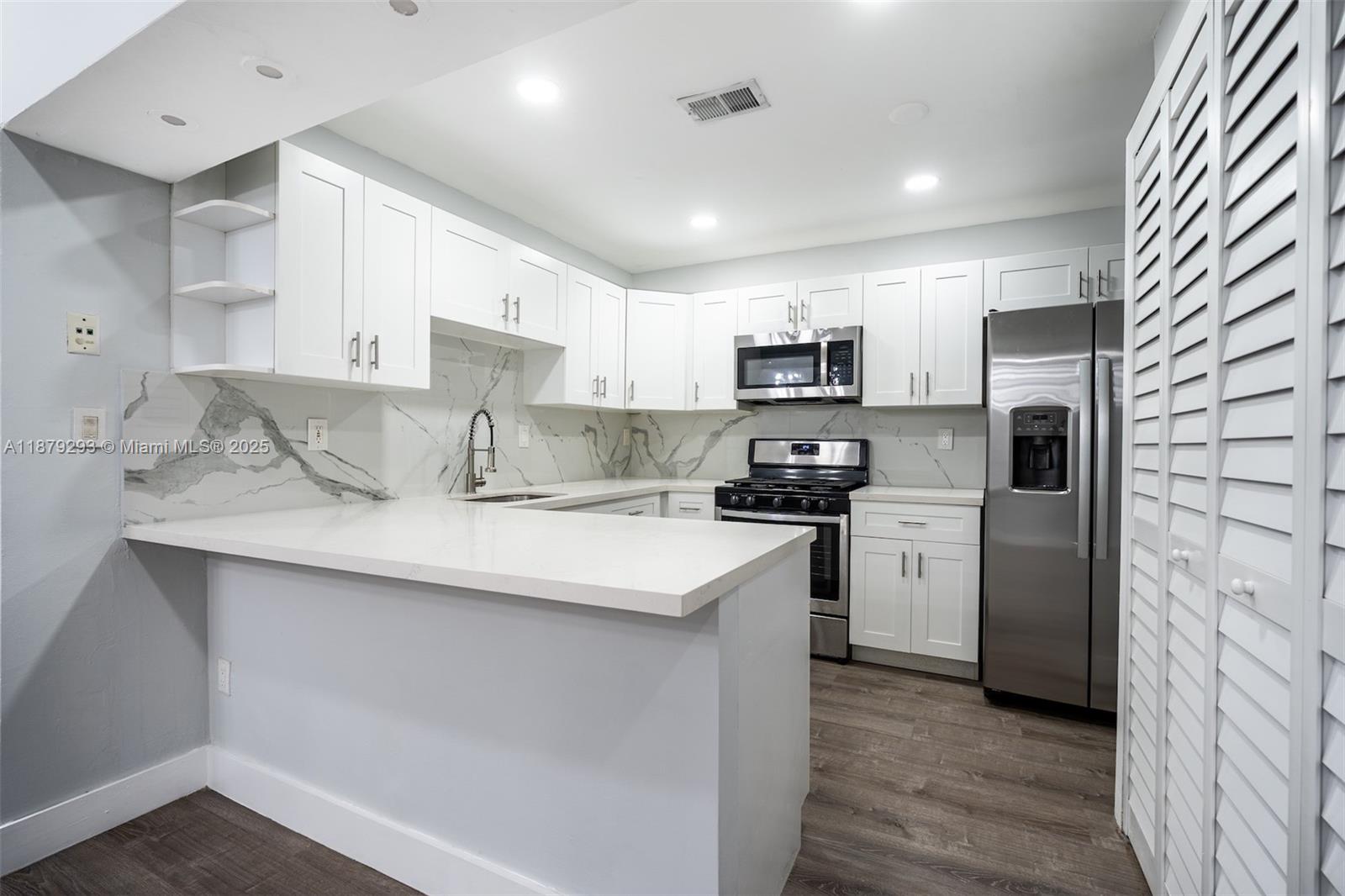 6211 Southwest 116th Place, Unit C22 Miami, FL 33173 - Photo 6 of 33 a kitchen with refrigerator cabinets and a sink