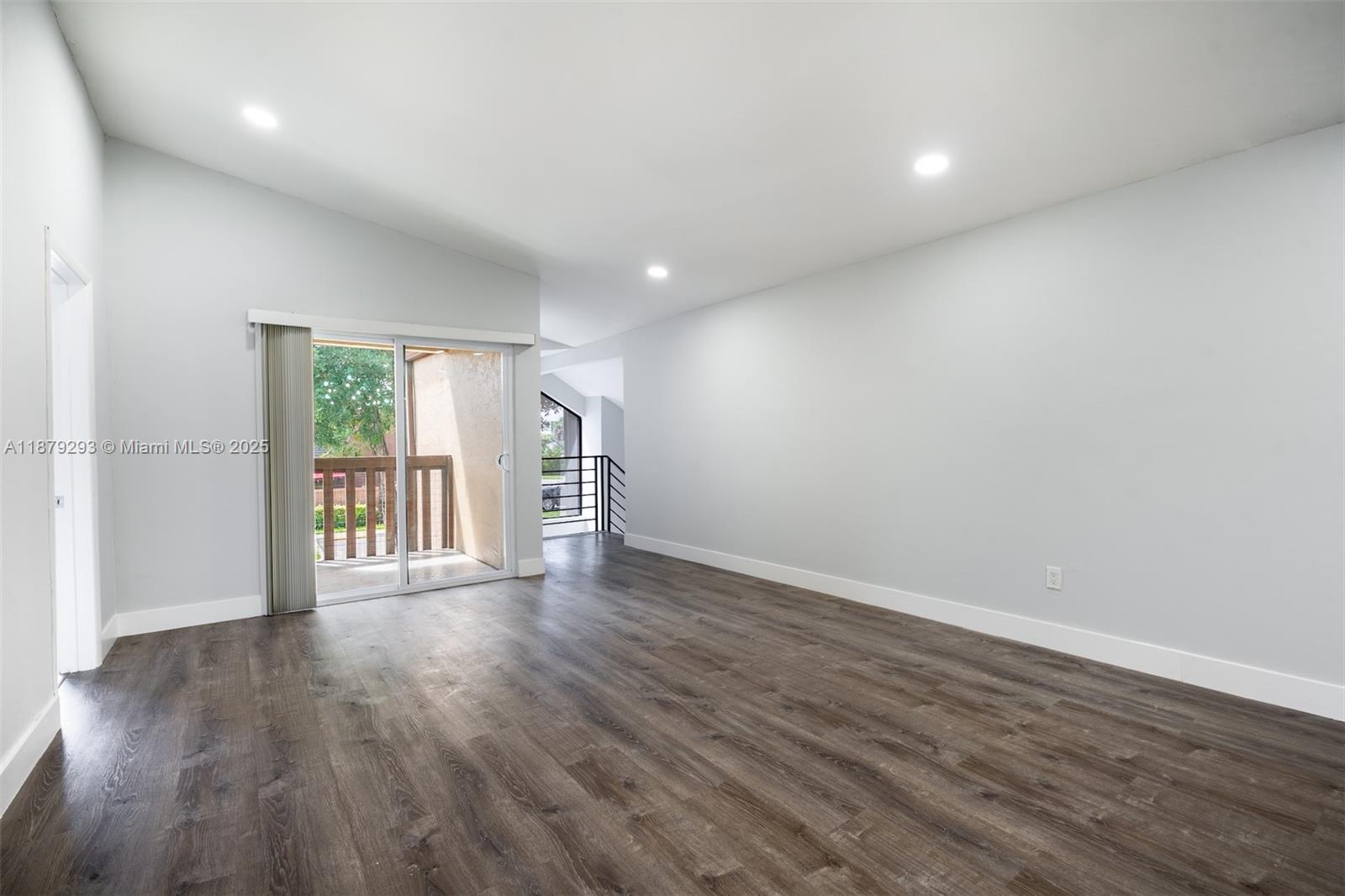 6211 Southwest 116th Place, Unit C22 Miami, FL 33173 - Photo 9 of 33 a view of an empty room with wooden floor and a window