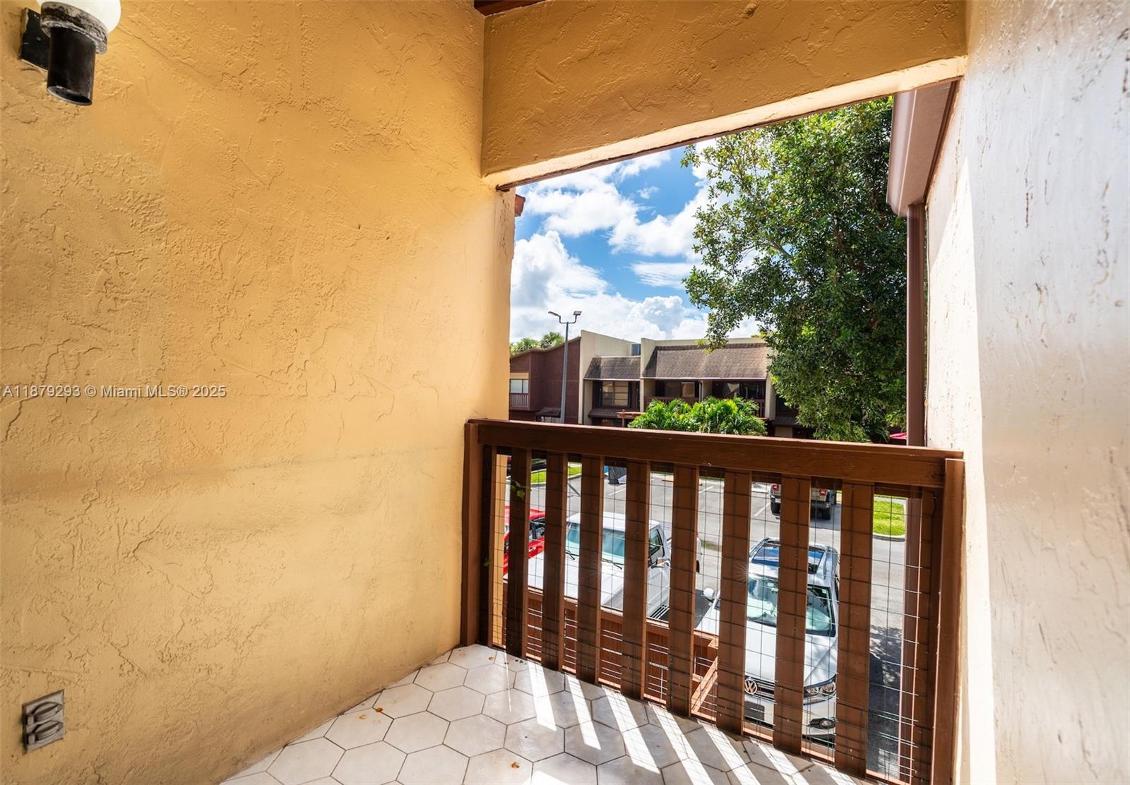6211 Southwest 116th Place, Unit C22 Miami, FL 33173 - Photo 10 of 33 a view of a balcony with wooden floor