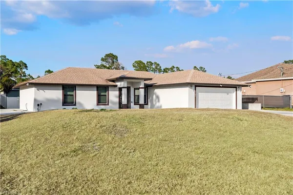 a front view of a house with a garden
