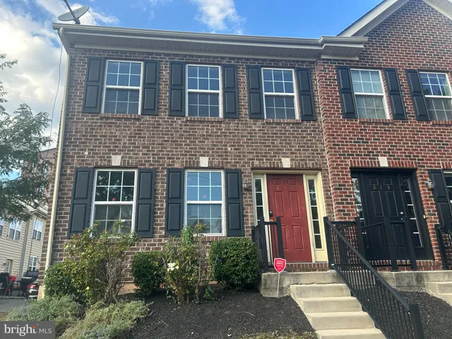 front view of a brick house with a yard