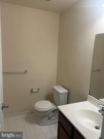 a white toilet sitting next to a bathroom sink