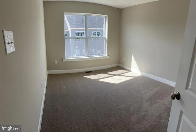 a view of an empty room with windows