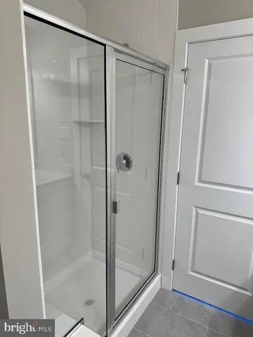 a bathroom with a glass shower door