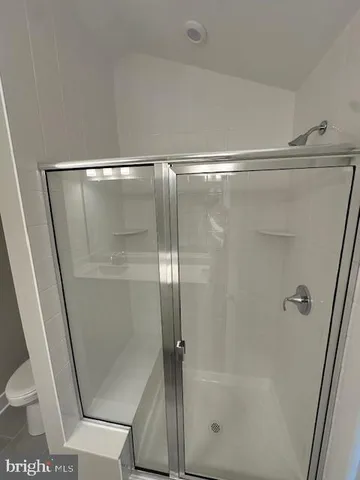 a bathroom with a glass shower door