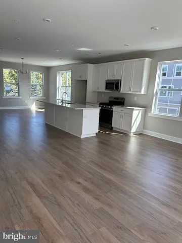 a view of kitchen with cabinets and wooden floor