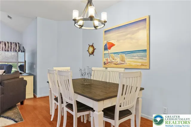 a living room with furniture a flat screen tv and kitchen view