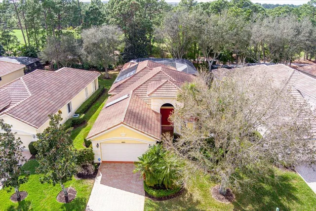 a aerial view of a house with a yard and potted plants