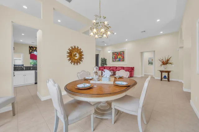 a dining room with furniture and chandelier