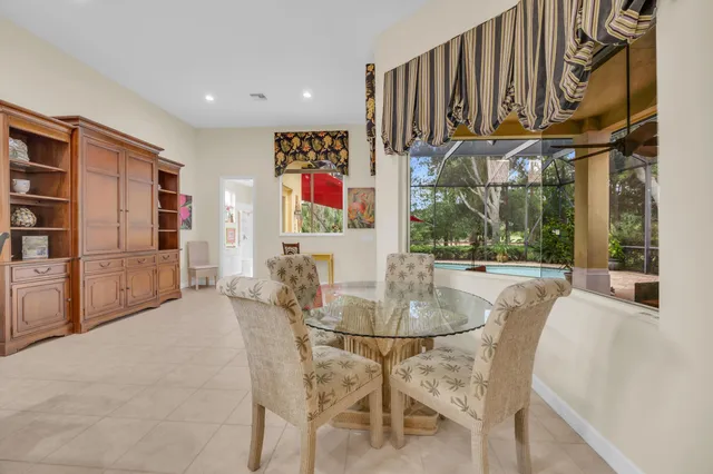 a dining room with furniture and a floor to ceiling window