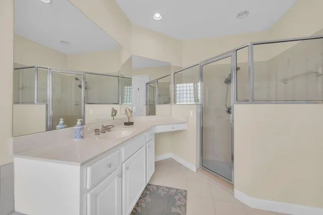 a bedroom with a bed and a refrigerator