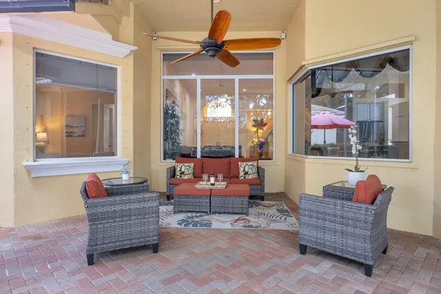 a kitchen with stainless steel appliances granite countertop a stove a sink and a red umbrella