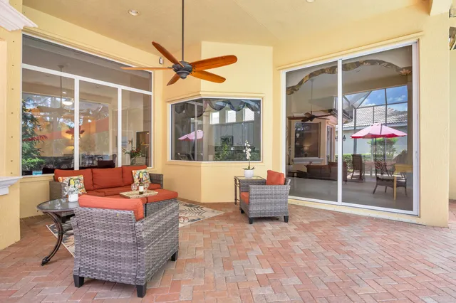 an outdoor space with swimming pool table and chairs