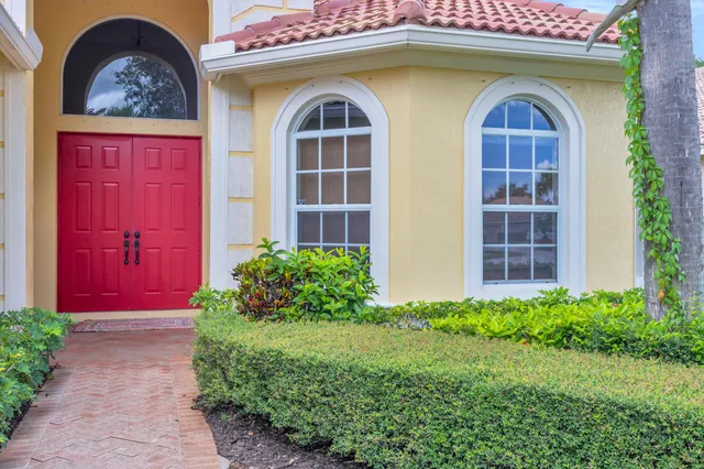 a front view of a house with a garden