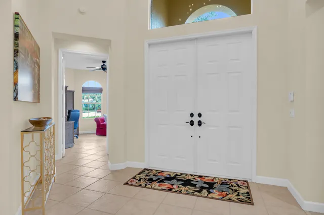 a view of a livingroom with wooden floor and a chandelier