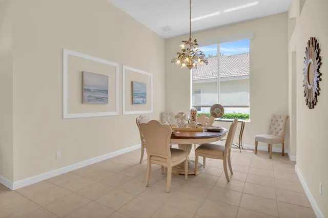 a dining room with furniture a chandelier and a rug