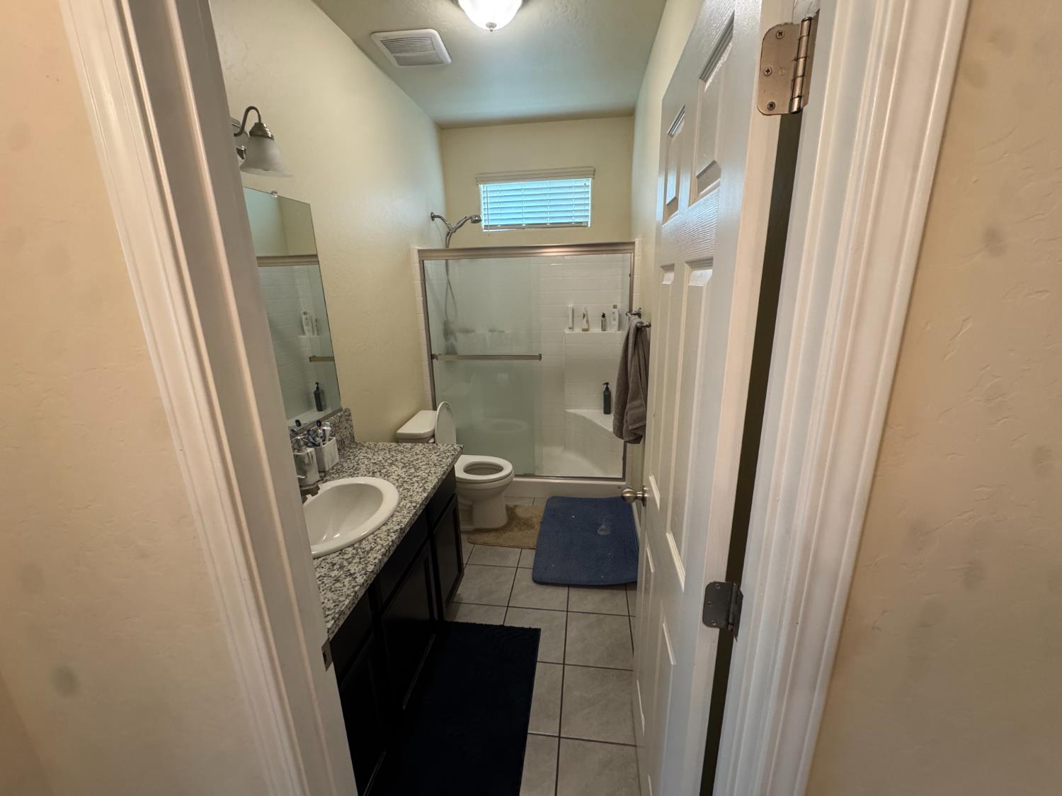 1726 Cleveland Street Selma, CA 93662 - Photo 11 of 17 a bathroom with a sink a mirror and a shower