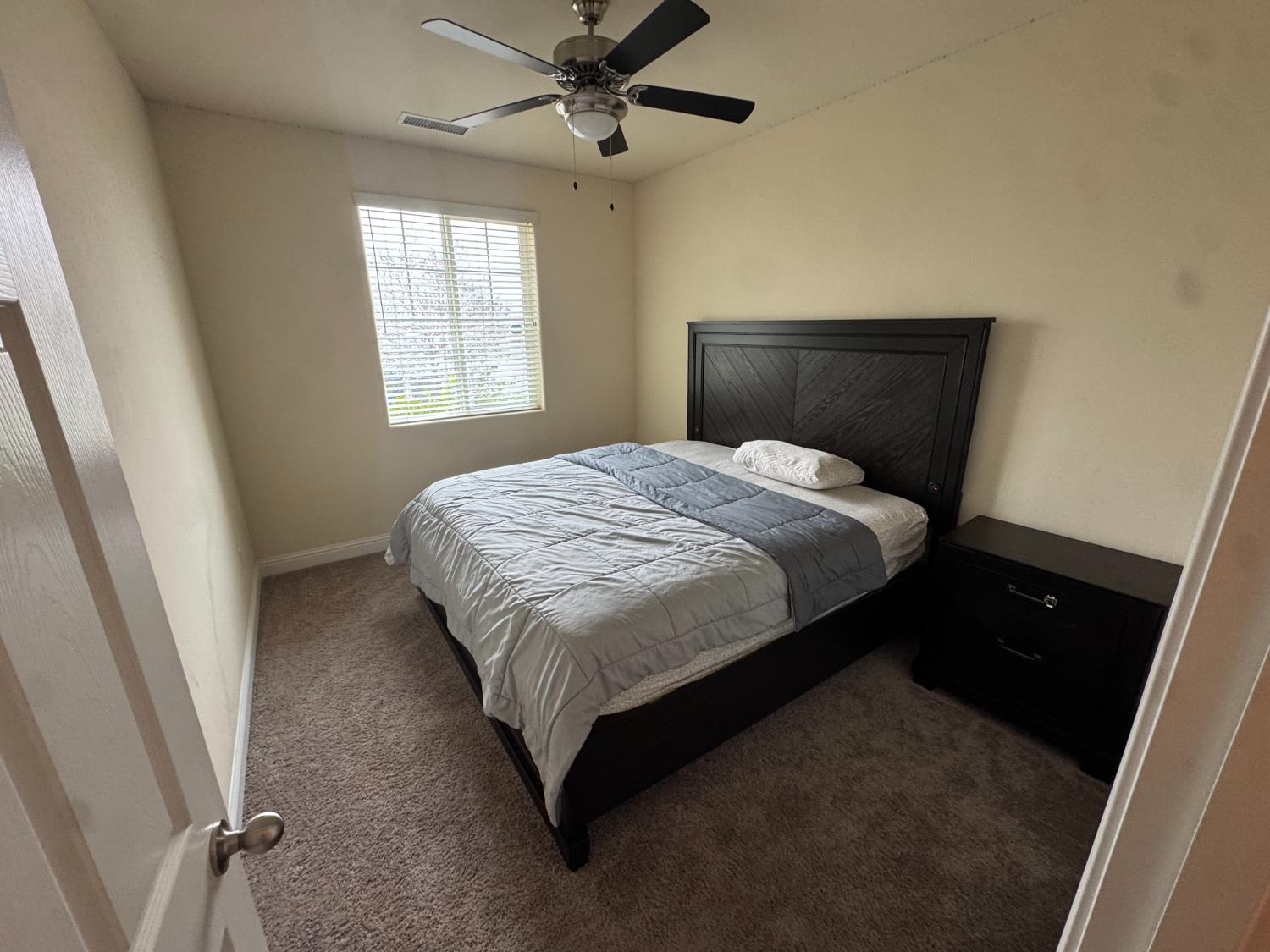 1726 Cleveland Street Selma, CA 93662 - Photo 12 of 17 a bedroom with a bed and window
