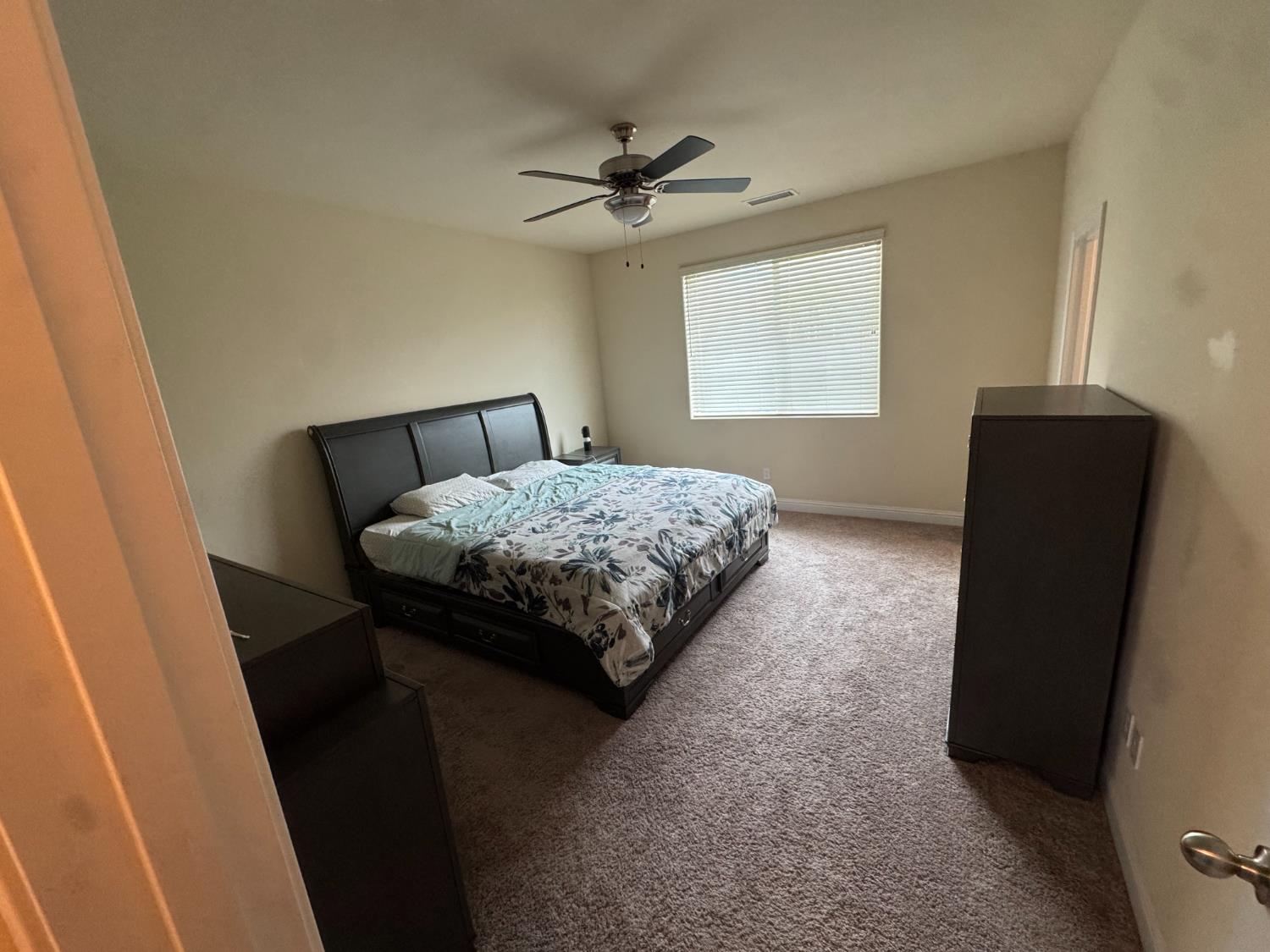 1726 Cleveland Street Selma, CA 93662 - Photo 8 of 17 a bedroom with a bed and a window