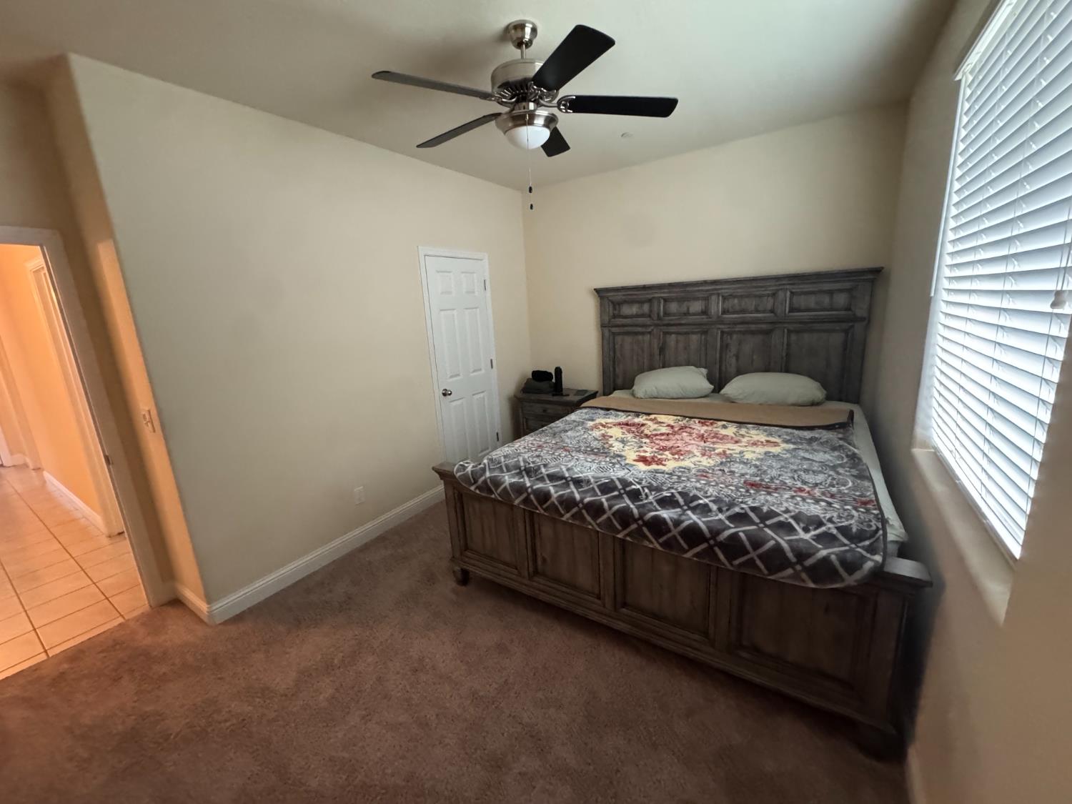 1726 Cleveland Street Selma, CA 93662 - Photo 9 of 17 a bed sitting in a bedroom next to a window