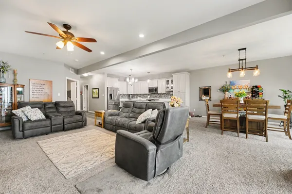 a dining room with furniture a chandelier and a rug