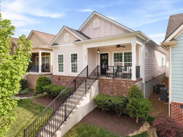 a front view of house with yard and green space